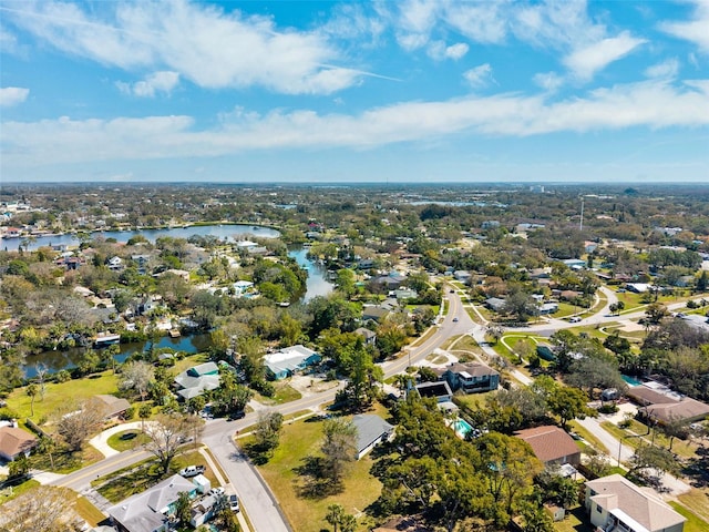 drone / aerial view with a water view and a residential view