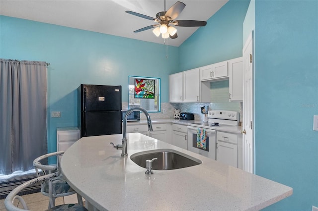 kitchen with sink, white electric range oven, tasteful backsplash, white cabinets, and black fridge