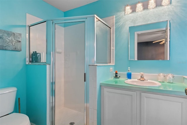 bathroom featuring vanity, a shower with shower door, and toilet