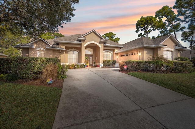 view of front of house with a yard and a garage