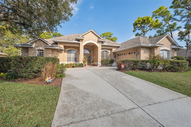 view of front facade featuring a garage and a front lawn