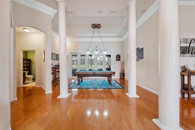 playroom with decorative columns, ornamental molding, and hardwood / wood-style flooring