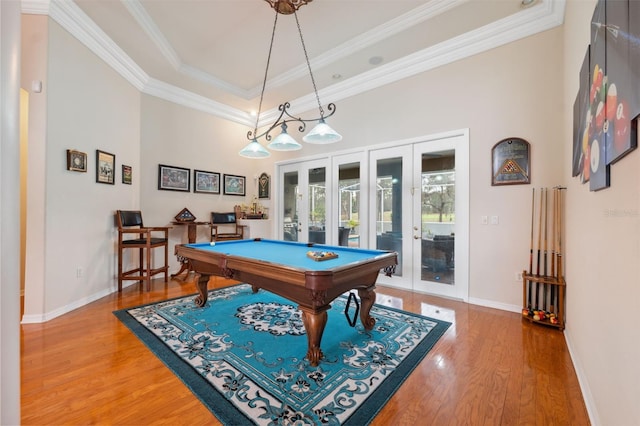 rec room with hardwood / wood-style floors, pool table, a raised ceiling, crown molding, and french doors