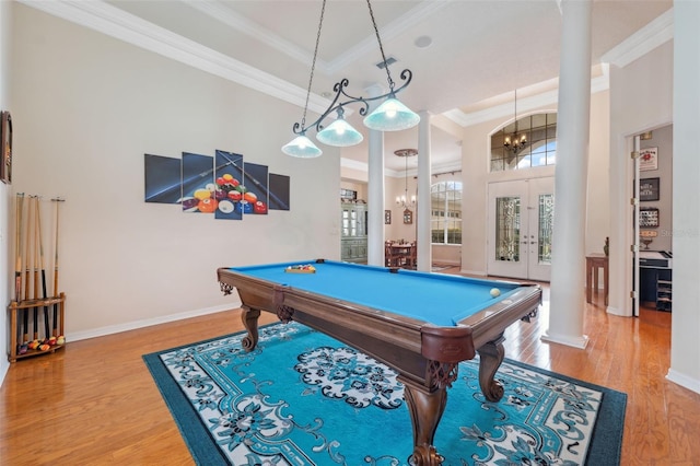 game room with ornate columns, ornamental molding, hardwood / wood-style floors, and french doors