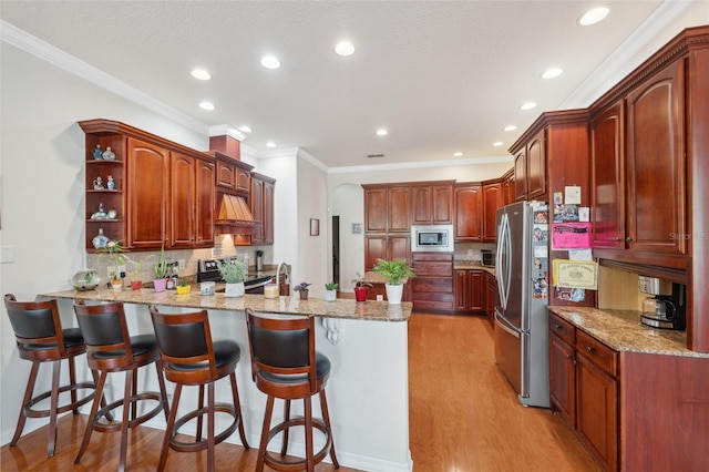 kitchen with decorative backsplash, stainless steel appliances, kitchen peninsula, and light wood-type flooring