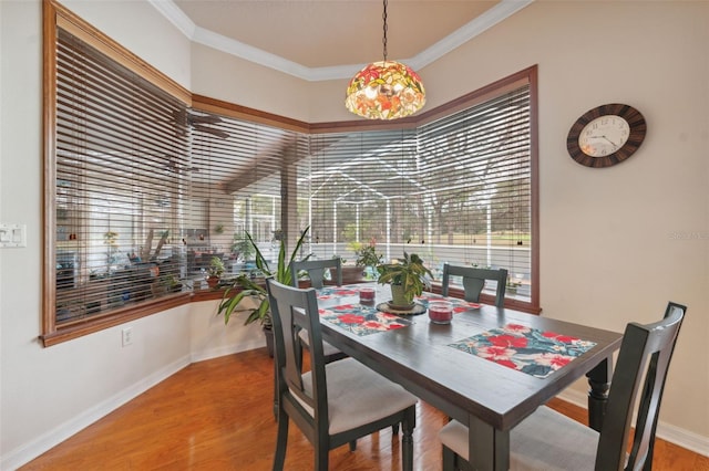 dining space featuring crown molding and wood-type flooring