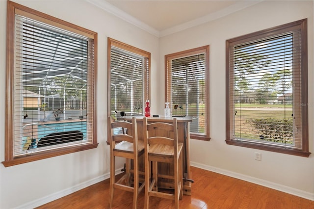 dining room featuring crown molding and wood-type flooring