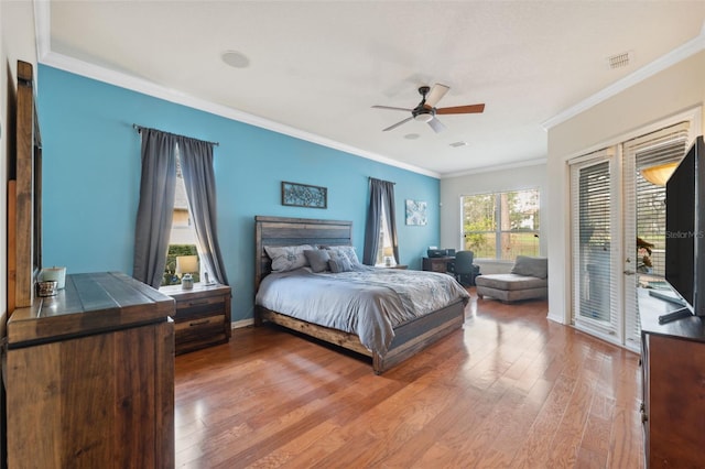 bedroom with ornamental molding, access to outside, hardwood / wood-style floors, and ceiling fan