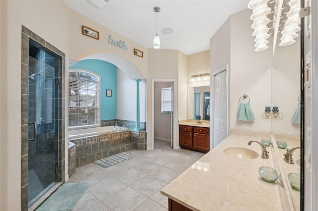 bathroom featuring vanity, tile patterned flooring, and shower with separate bathtub