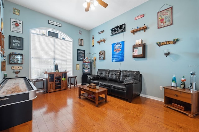 living room featuring hardwood / wood-style flooring and ceiling fan