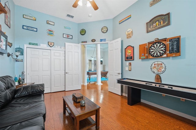 living room featuring hardwood / wood-style flooring and ceiling fan