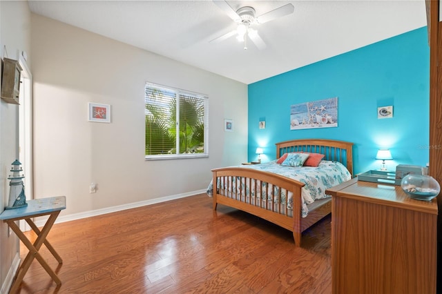 bedroom with hardwood / wood-style flooring and ceiling fan