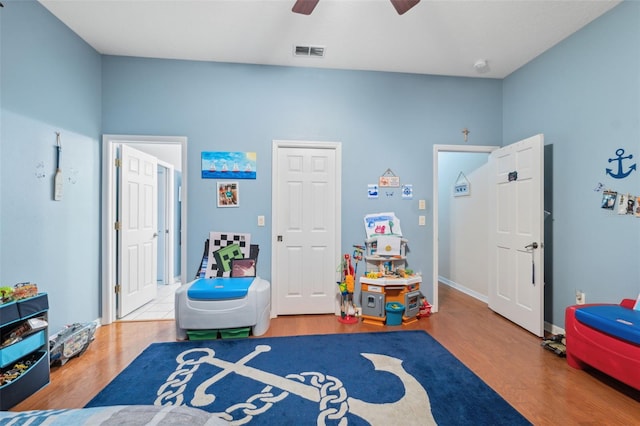 rec room with hardwood / wood-style flooring and ceiling fan