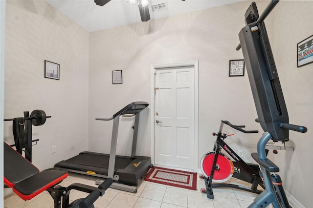 workout room featuring ceiling fan and light tile patterned floors