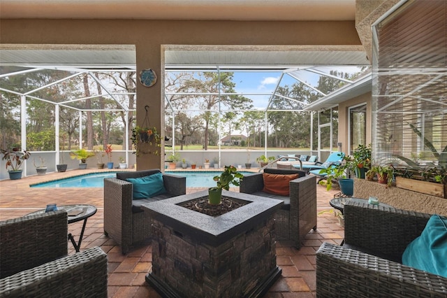 view of patio with an outdoor living space with a fire pit and glass enclosure