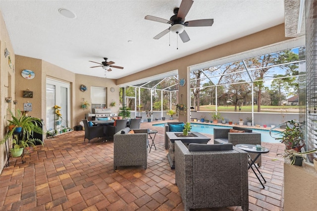 view of patio / terrace featuring ceiling fan and glass enclosure