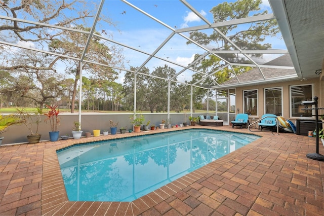 view of swimming pool featuring a lanai and a patio