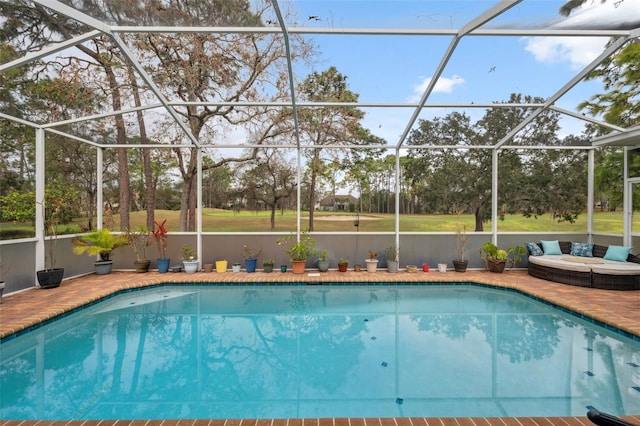 view of pool with a patio and glass enclosure