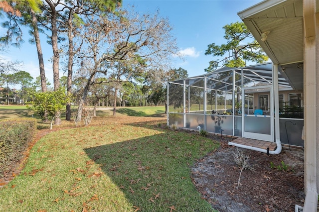 view of yard with a water view and a lanai