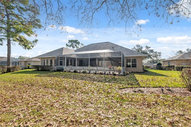 rear view of house featuring a yard and a lanai