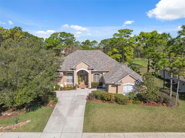 view of front of house with a front yard and french doors