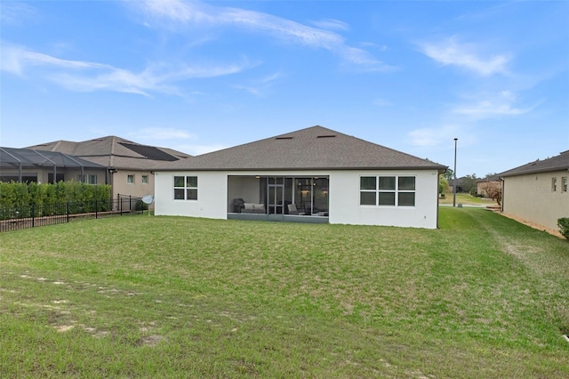 back of house featuring a yard, roof with shingles, fence, and stucco siding