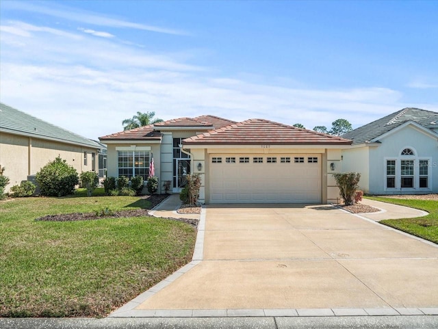 view of front of home with a garage and a front lawn