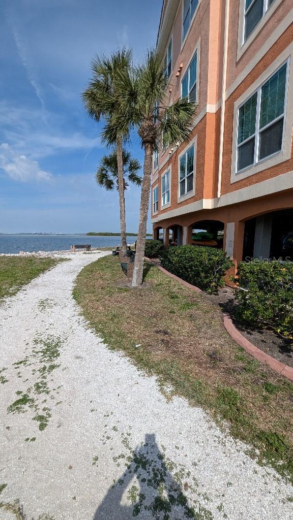 view of home's community featuring a beach view and a water view