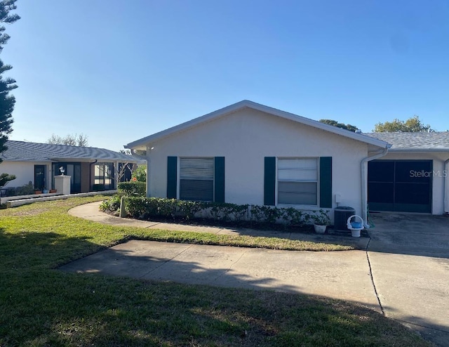 view of property exterior featuring a garage and a lawn