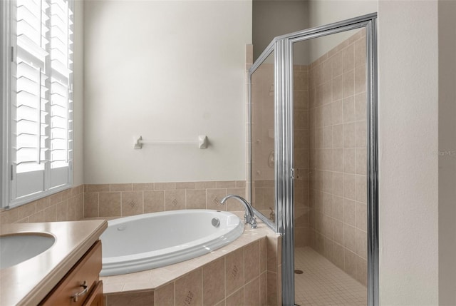 bathroom featuring vanity and separate shower and tub