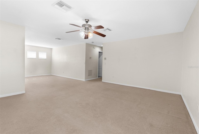 empty room with ceiling fan and light carpet