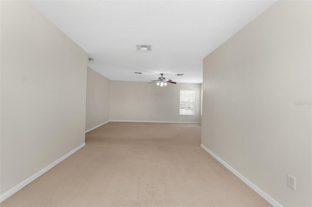 unfurnished room featuring light colored carpet and ceiling fan