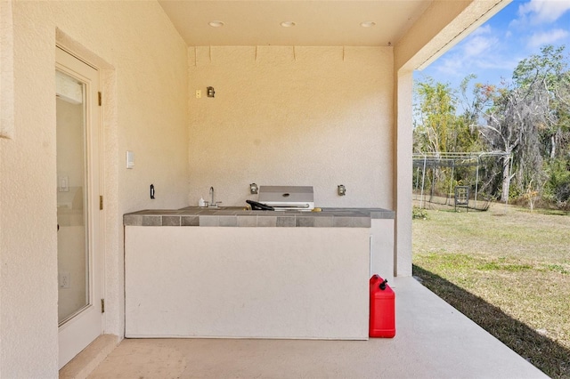 view of patio with sink and grilling area