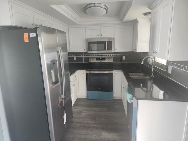 kitchen with sink, ornamental molding, stainless steel appliances, and white cabinets