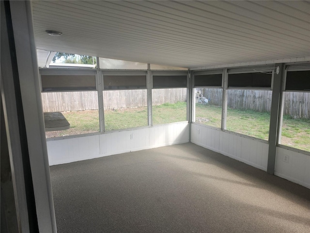 unfurnished sunroom with lofted ceiling