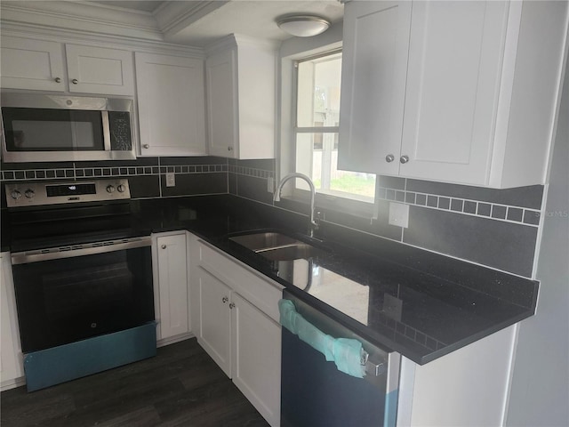 kitchen featuring sink, white cabinetry, backsplash, stainless steel appliances, and dark hardwood / wood-style flooring