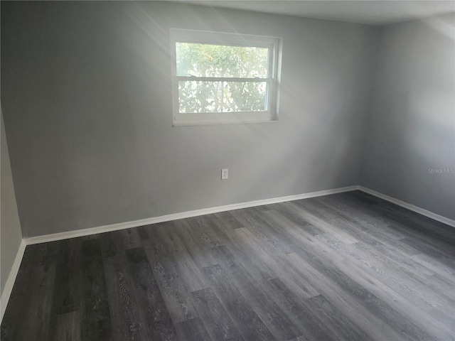 spare room with dark hardwood / wood-style flooring