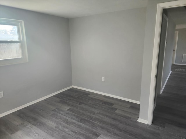 spare room featuring dark hardwood / wood-style flooring