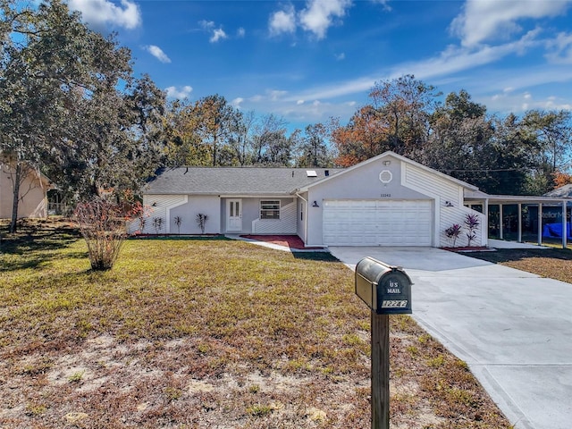 single story home with a garage, concrete driveway, and a front yard