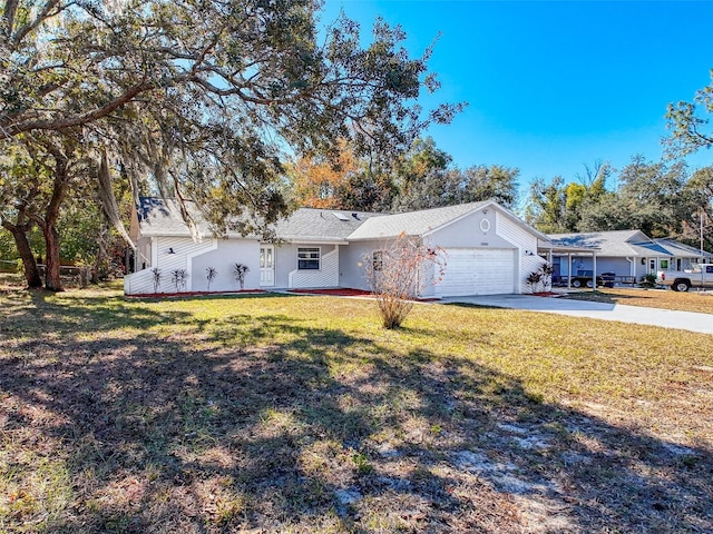 ranch-style house featuring a garage, concrete driveway, and a front lawn