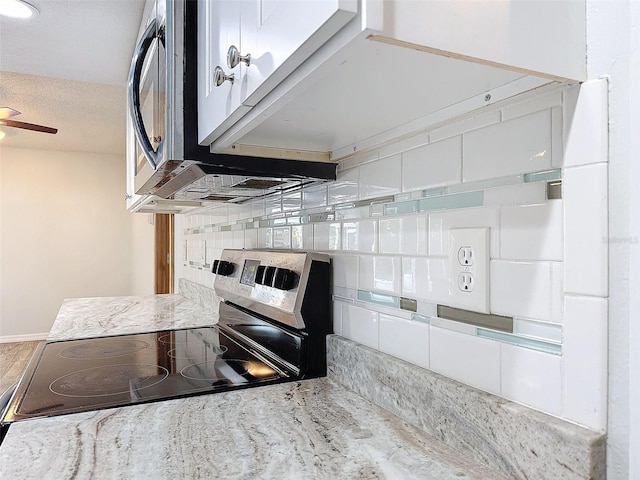 interior space featuring light stone countertops, stainless steel appliances, and decorative backsplash