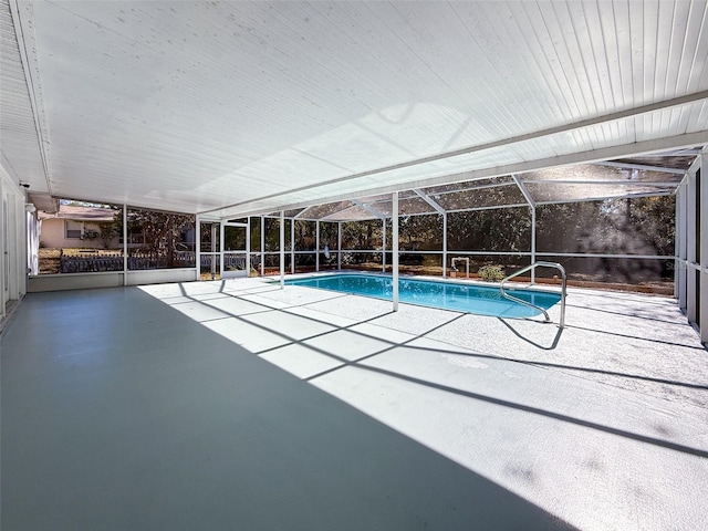 outdoor pool with a lanai and a patio area