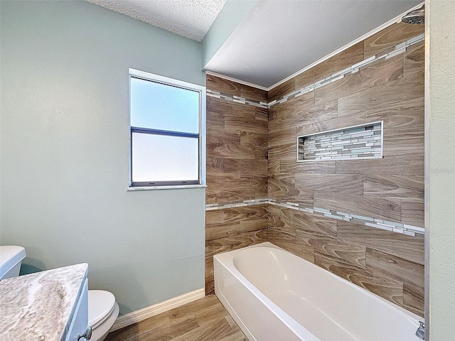 full bath featuring a textured ceiling, toilet, wood finished floors, baseboards, and a tub