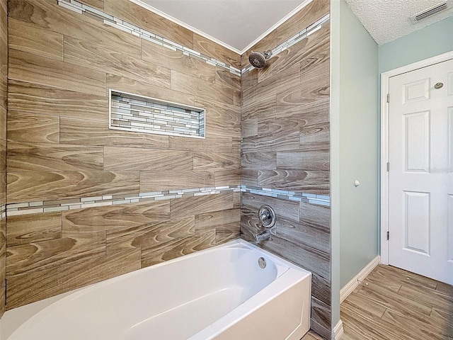 bathroom featuring a shower, visible vents, a bathing tub, wood finished floors, and baseboards