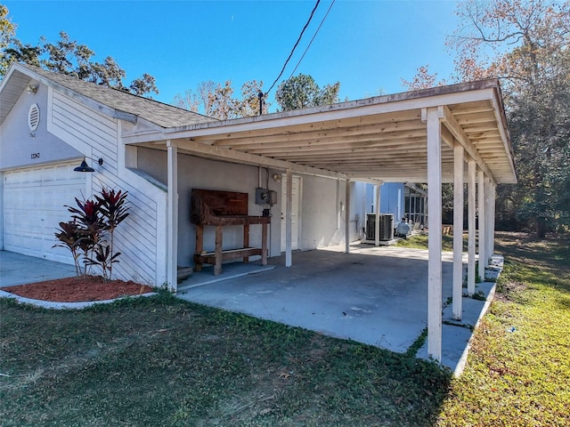 exterior space with driveway, a garage, and a carport