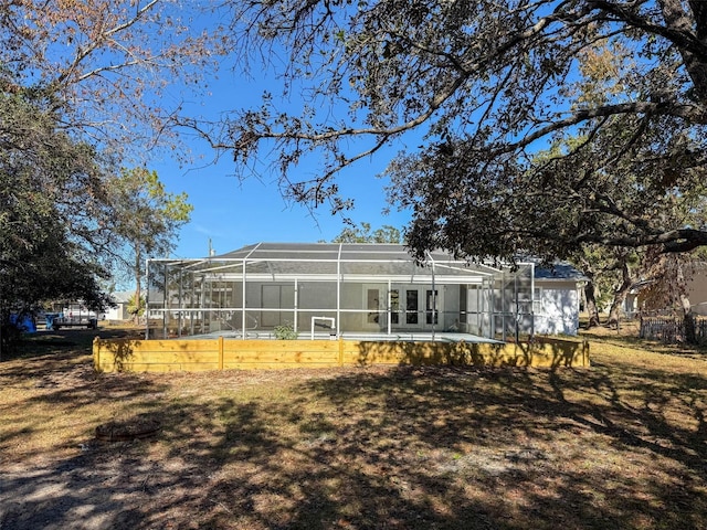 back of house featuring glass enclosure