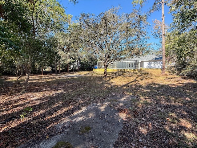 view of yard featuring a lanai