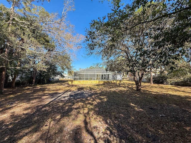 view of yard with glass enclosure