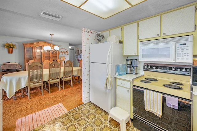 kitchen with visible vents, white appliances, light floors, light countertops, and a chandelier