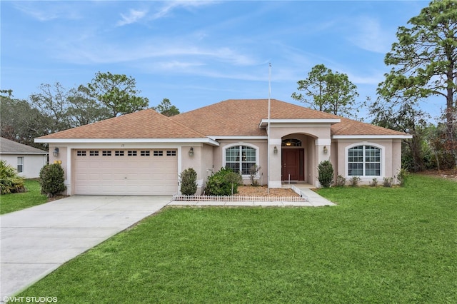 view of front of house featuring a garage, driveway, a front lawn, and stucco siding